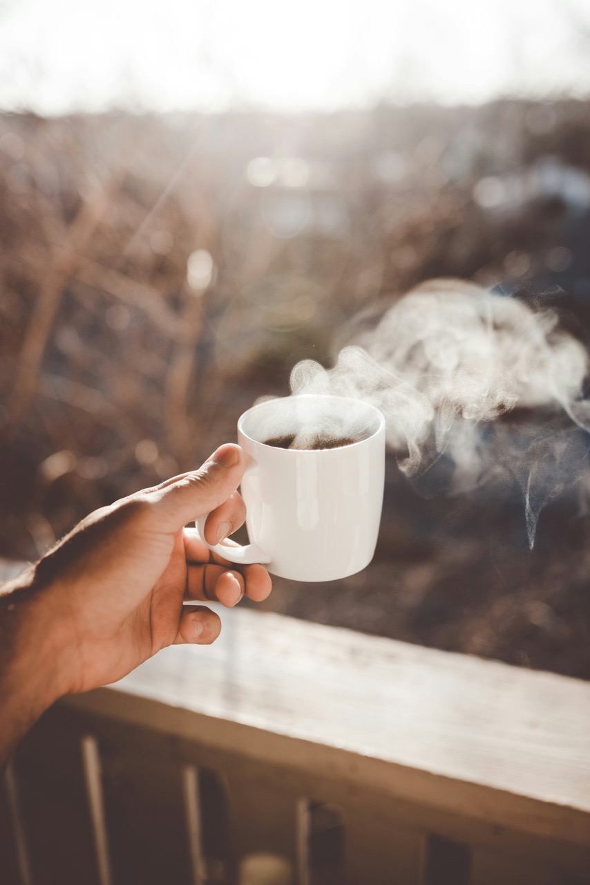 Person holding white ceramic cup with hot coffee photo – Free Coffee Image on Unsplash